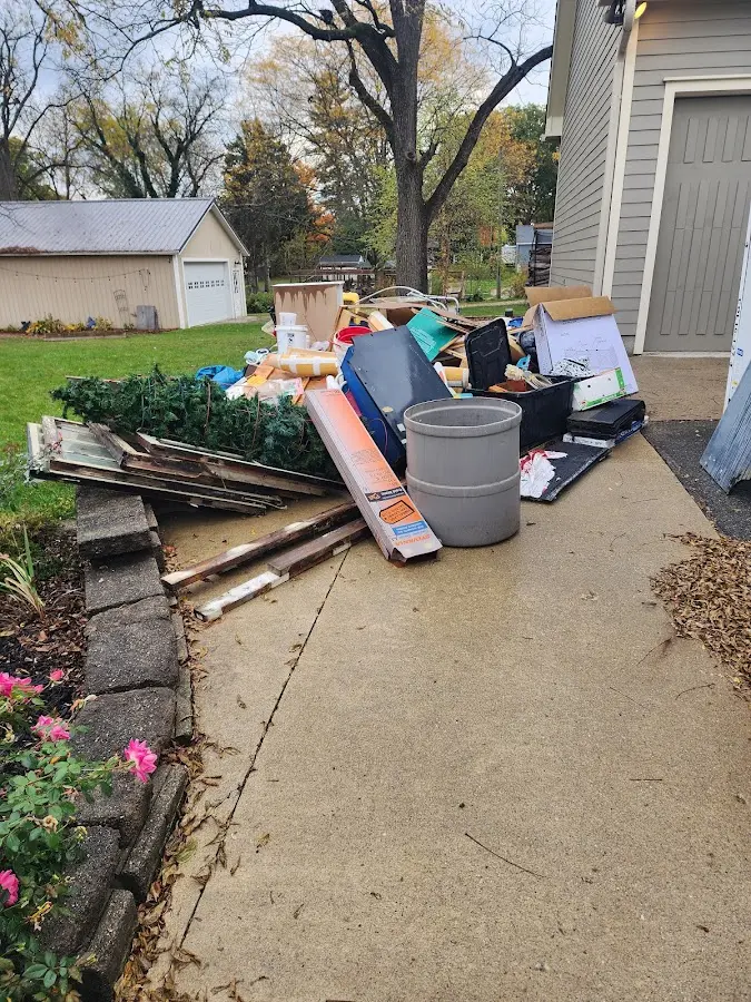 Dumpster being loaded with debris for 3 Yard Dumpster Rental in Farmingdale